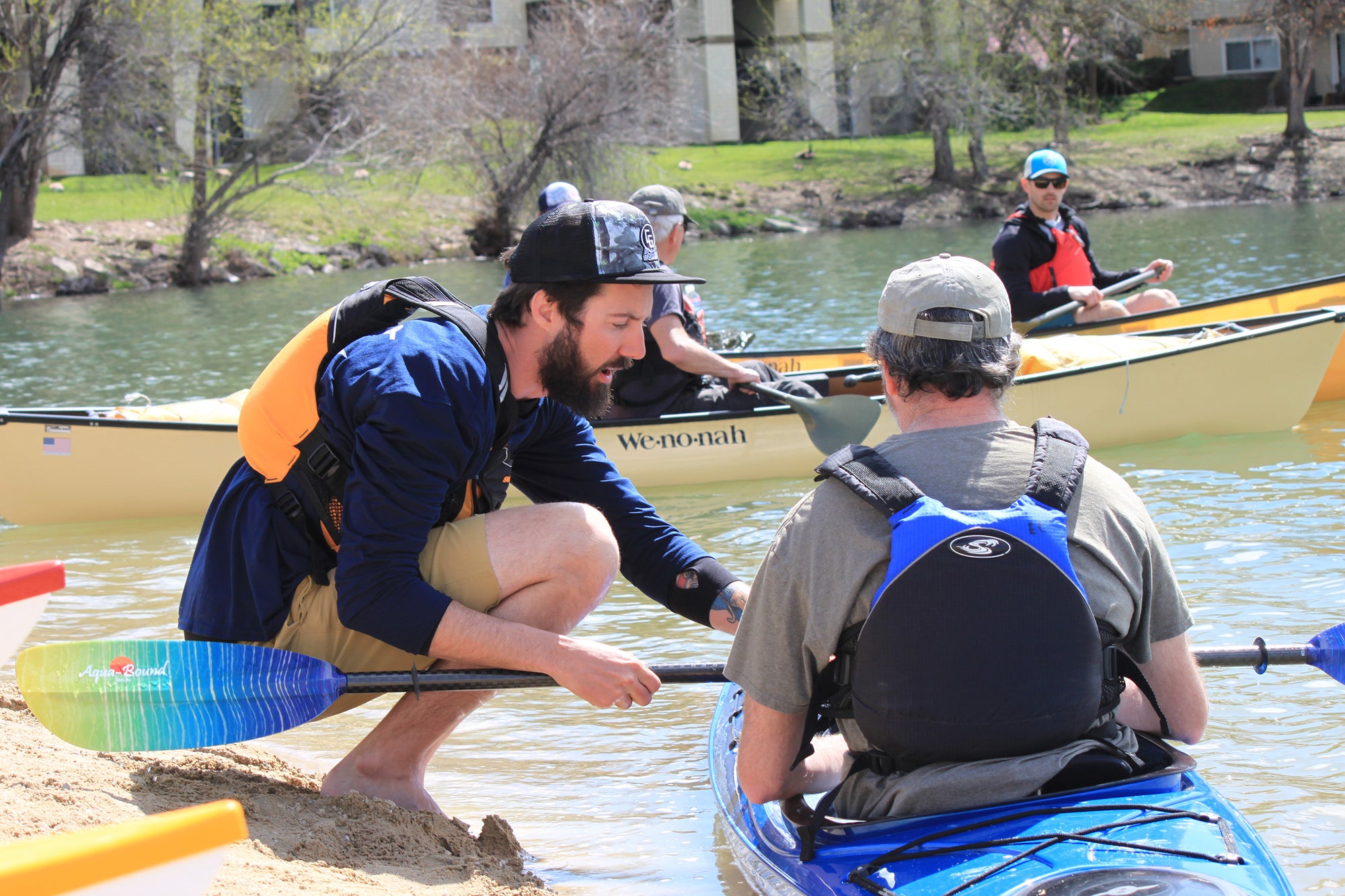 Nick Wittman helps F.I.T an Eddyline Customer to his kayak